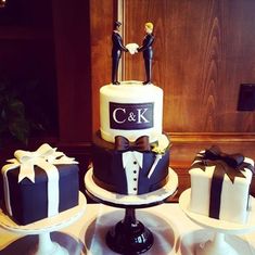 three tiered cake decorated with black and white fondant, bow ties and groom's initials