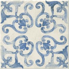 a blue and white tile with swirls on it