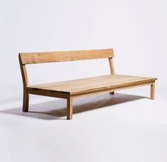 a wooden bench sitting on top of a white floor