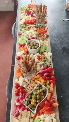 a long table filled with vegetables and crackers