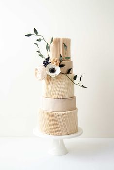 a three tiered cake with flowers on top