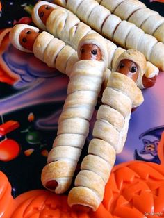 two hot dogs wrapped in banana peels on top of halloween decorations