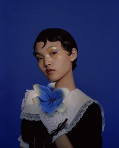 a mannequin with a blue flower on it's collar