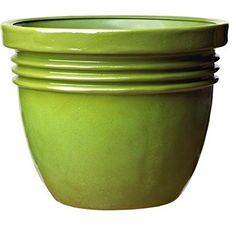 a stack of green bowls sitting on top of each other in front of a white background