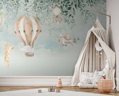 a child's room decorated in pastel tones with an air balloon wall mural