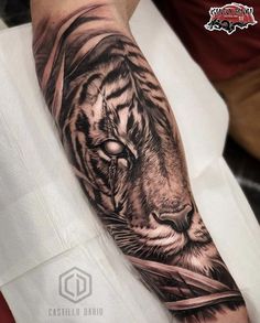 a man with a tiger tattoo on his arm