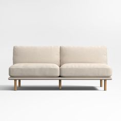 a white couch sitting on top of a wooden frame