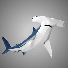 an origami shark is floating in the air