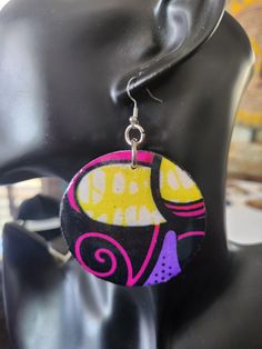 These large lightweight statement tribal earrings will enhance any ethnic clothing ensemble you have in mind or just adorn these with your solid colors and bring out the boldness you love. The wood earrings measure  2.5 inches in diameter. The front fabric is covered with resin which makes the colors so vibrant, never to fade. The back of the wood is painted. Unique Plug Earrings For Festivals, Unique Earrings With Artistic Design, Unique Drop Earrings For Festival, Circular Festival Earrings With Hooks, Unique Artistic Design Earrings For Festival, Artisan Earrings With Artistic Design For Festivals, Yellow Festival Earrings With Matching Pair, Festival Multicolor Single Earring, Traditional Yellow Earrings For Festival