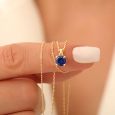 Celebrate the beauty of simplicity and elegance with our 14K Solid Gold Round Sapphire Pendant Necklace, designed to showcase the timeless allure of September's birthstone, sapphire. This delicate necklace is perfect for those who appreciate minimalist, dainty jewelry that can effortlessly transition from everyday wear to special occasions. At the heart of this piece is a stunning round sapphire, expertly cut to capture and reflect light with every movement. Known for its deep blue hue, sapphire Sapphire Pendant Necklace, Custom Jewelry Box, Sapphire Necklace Pendants, Round Sapphire, Sapphire Pendant, September Birthstone, Gift For Birthday, Delicate Necklace, Dainty Jewelry