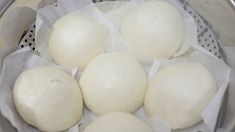 four balls of dough in a strainer basket