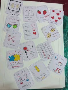 a bunch of cards that are on top of a paper sheet with words and pictures