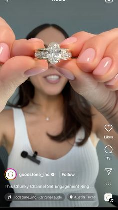 a woman holding up a ring in front of her face with the caption, good stone inc follow this chunky channel set engagement ring