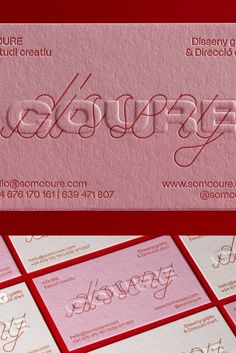 some business cards with red and white lettering on them