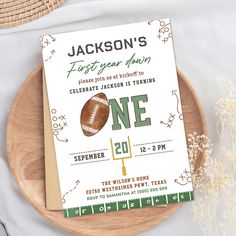 a football themed birthday party card on a wooden plate