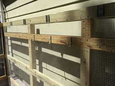 the inside of a building that is being constructed with wood and metal mesh fencing on it