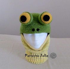 a crocheted frog hat and scarf with big eyes