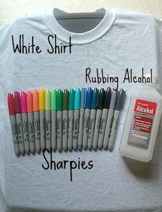 a white shirt with writing on it next to some markers and a t - shirt that says, white shirt rubbing alcohol sharpies