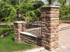 a stone fence with a bench in front of it