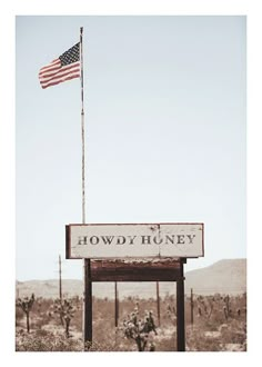 an american flag flying over the sign for howdy huney, in arizona