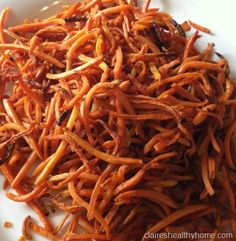 shredded carrots on a white plate ready to be eaten