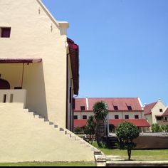 an outside view of a building with stairs leading up to it