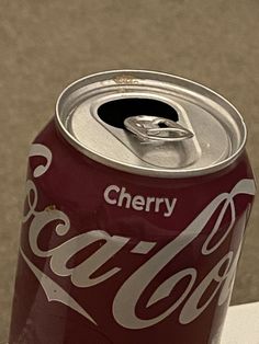 a can of coca cola sitting on top of a table