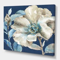 a white flower with blue leaves on a dark background canvas wall art print, ready to hang