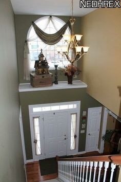 an overhead view of a staircase leading up to a foyer with two doors on each side