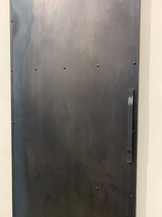 a large metal door with rivets on it