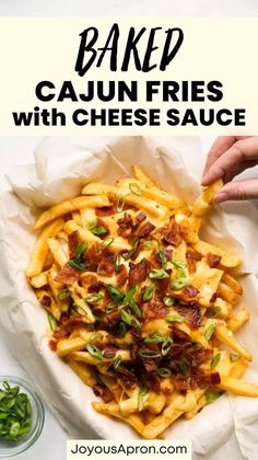 baked cajun fries with bacon, cheese and green onions in a white serving dish