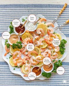 a white plate topped with shrimp and lemons