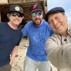 three men taking a selfie on the beach