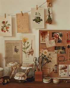 a wooden table topped with lots of pictures and papers