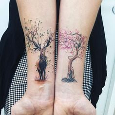 two people with matching tattoos on their arms, one has a deer and the other has a tree