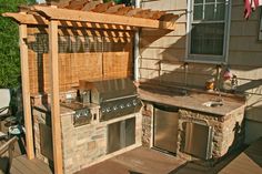 an outdoor kitchen with grill and sink