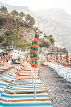 rows of beach chairs lined up with an umbrella