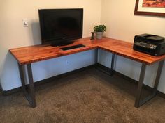 a corner desk with a computer monitor and printer on it