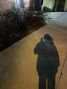 the shadow of a person standing in front of a building