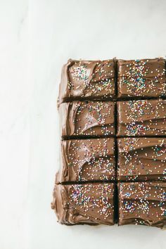 chocolate cake with sprinkles on white surface