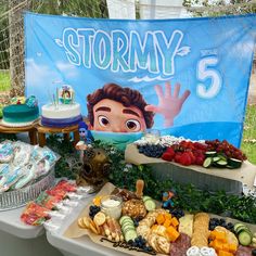 a table filled with lots of food next to a sign