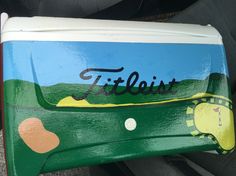 a green and blue painted suitcase with the word frisbee on it's side