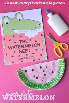 paper plate watermelon seed craft with scissors, glue and book on pink background