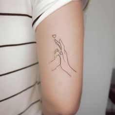 a woman's arm with a small tattoo on the left side of her arm