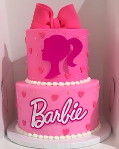 a pink cake with a barbie silhouette on it