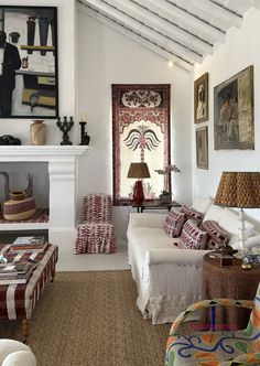 a living room filled with lots of furniture next to a fire place in a house