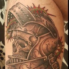 a skull with a helmet on it's head is shown in this tattoo design