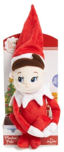 the elf plush toy is sitting in front of a box with it's eyes open