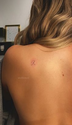 a woman with a small tattoo on her back