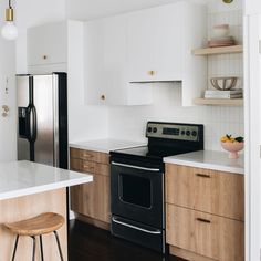 a black stove top oven sitting inside of a kitchen